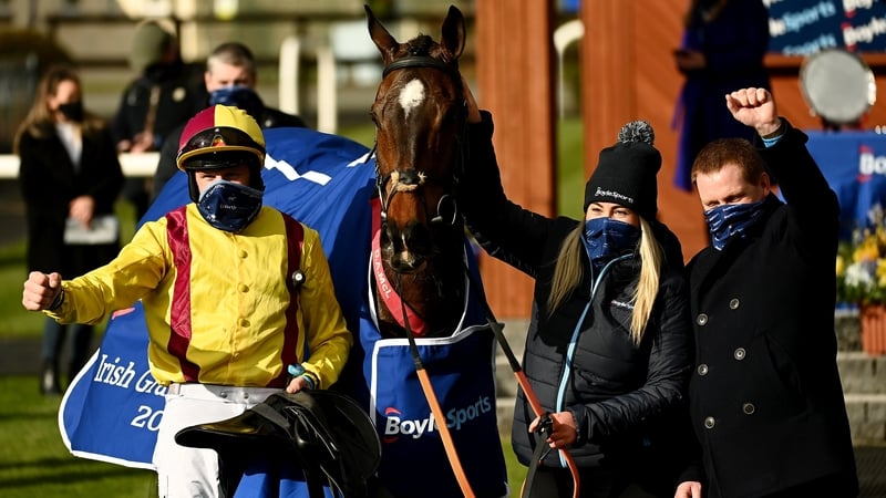 Jockey Ricky Doyle (L), handler Molly O'Connor and trainer Dermot McLoughlin (R) celebrate after Freewheelin Dylan's Grand National win last year