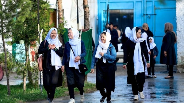 Girls smiling as they arrived at school this morning before they were told to go home
