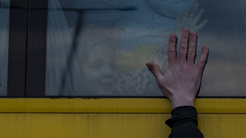 A father says goodbye to his family as they leave for Poland on a bus on March 03, 2022 in Lviv, Ukraine