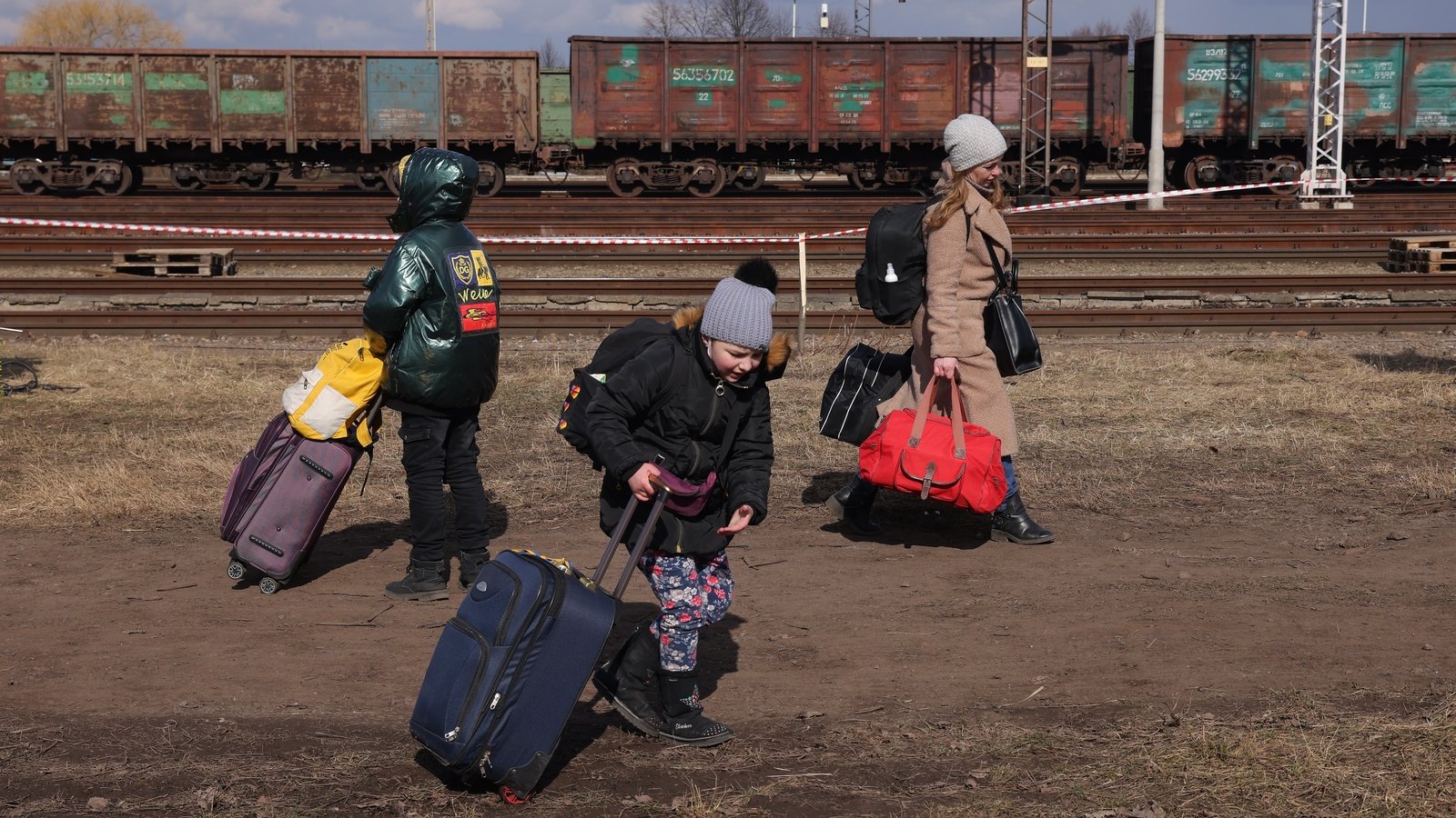 Women and children flee a war-torn Ukraine