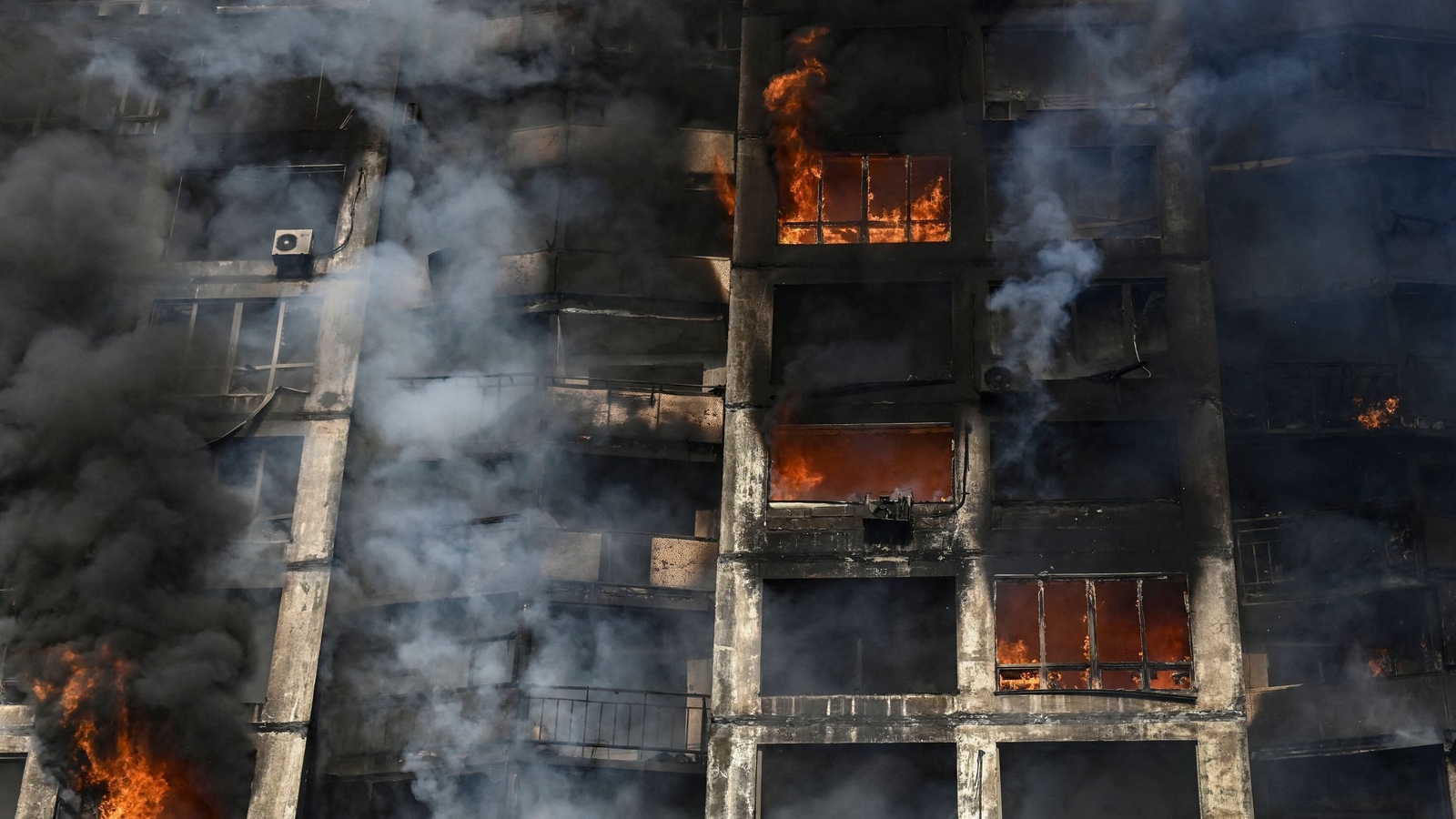 Firefighters extinguish a fire in an apartment building in Kyiv after strikes on residential areas