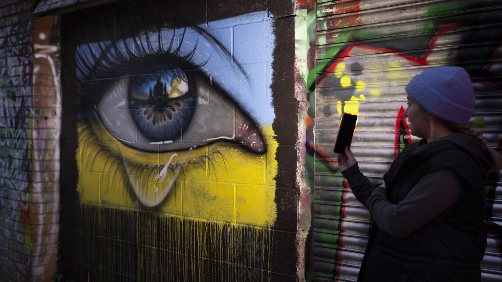 Graffiti artwork in Wales shows a weeping eye in the colours of a Ukrainian flag