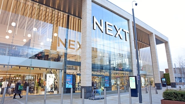 a Next store with big glass windows and the company logo