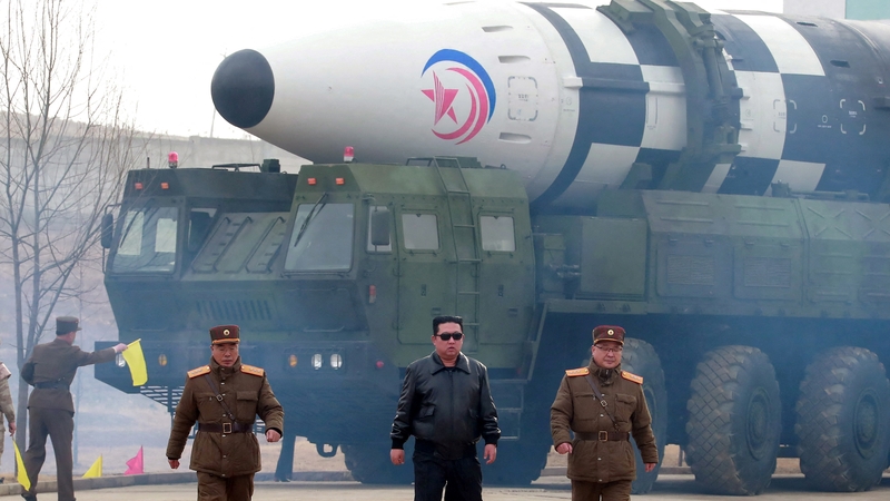 Kim Jong-un walks away from what state media said was a 'new type' of ICBM in this undated photo released on 24 March
