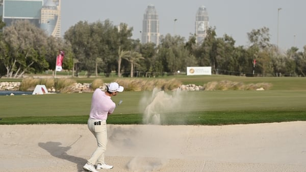 Co-leader Matthew Jordan plays his bunker shot on the 18th hole