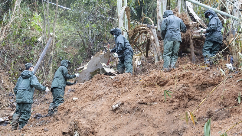 Rescuers work at the site of the plane crash earlier this week