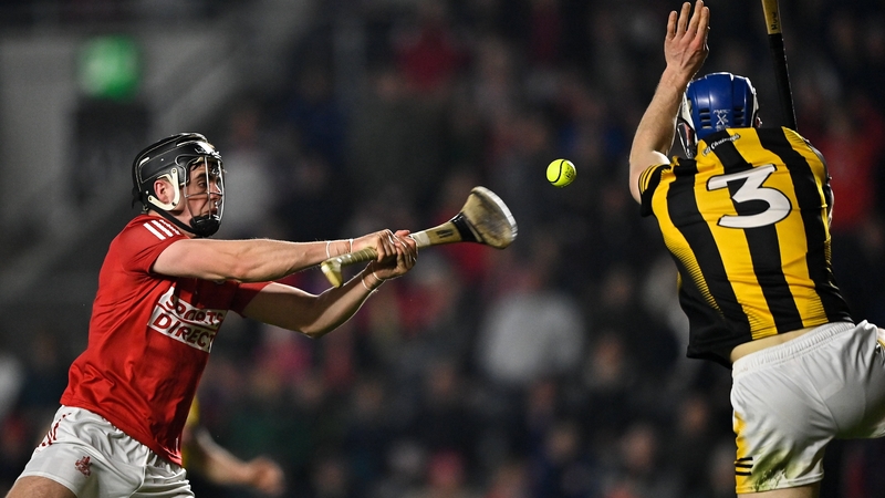 Darragh Fitzgibbon shoots to score Cork's second-half goal despite the attempted block down from Huw Lawlor