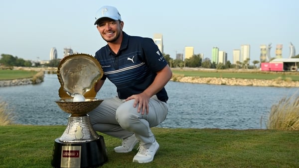 Ewen Ferguson celebrates with the winner's trophy