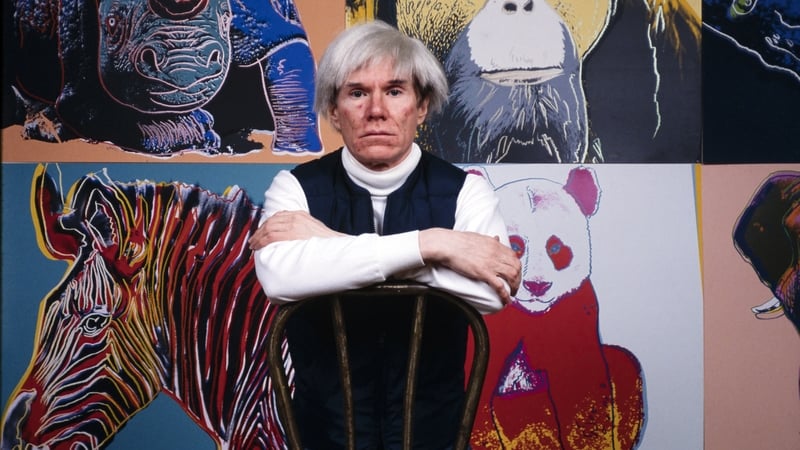 Andy Warhol in front of several paintings in his Endangered Species at The Factory in 1982. Photo: Brownie Harris/Corbis via Getty Images