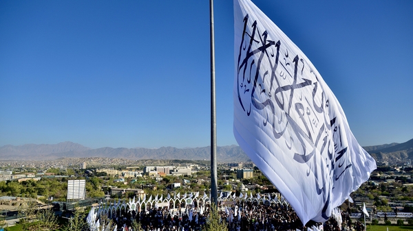 A giant Taliban flag is hoisted on the Wazir Akbar Khan hill in Kabul