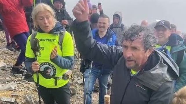Charlie and his wife Claire celebrate as they reach the summit