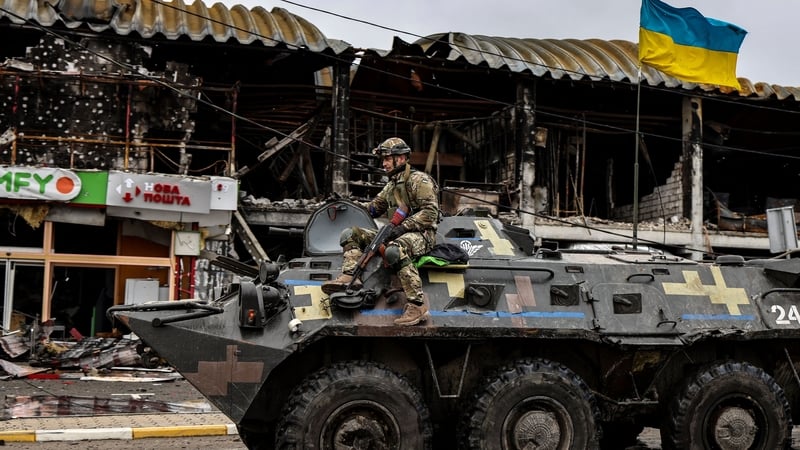 A Ukrainian soldier patrols in an armoured vehicle a street in Bucha, northwest of Kyiv