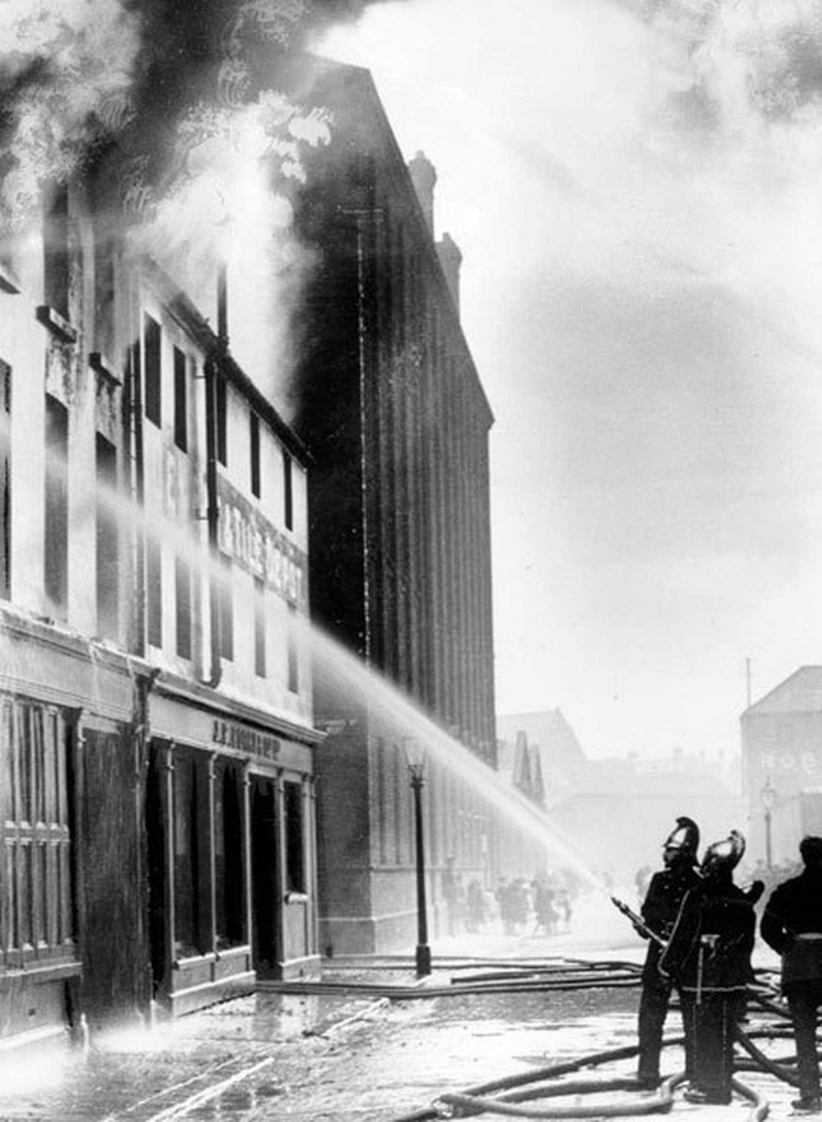 Firemen hose down buildings destroyed in Belfast riots, February 1922 (Courtesy of Belfast Telegraph)