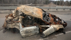 A damaged car near the cemetery at the entrance to the city of Borodyanka