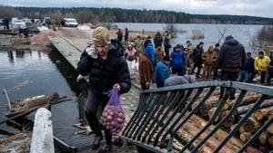 Soldiers and civilians repair a destroyed bridge over the Irpin River in Demydiv
