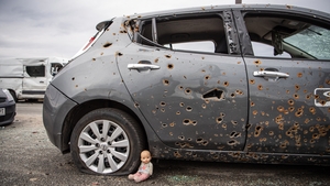 A bullet-riddled car on a bridge to Irpin, a town near Kyiv from which occupying Russian troops recently withdrew following intense fighting with Ukrainian forces
