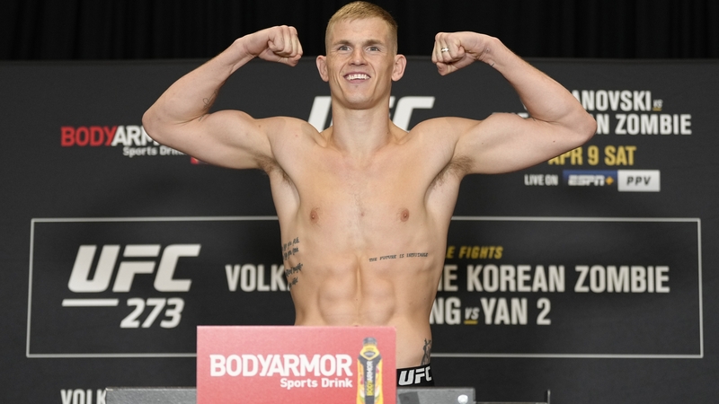 Ian Garry poses on the scale during the UFC 273 official weigh-in