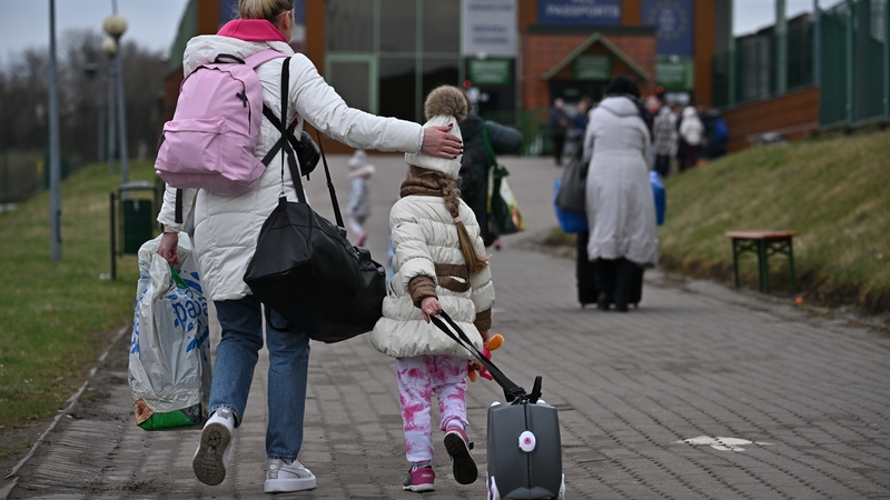 Millions of Ukrainians have fled the war - a woman and child are seen crossing into Poland at Medyka