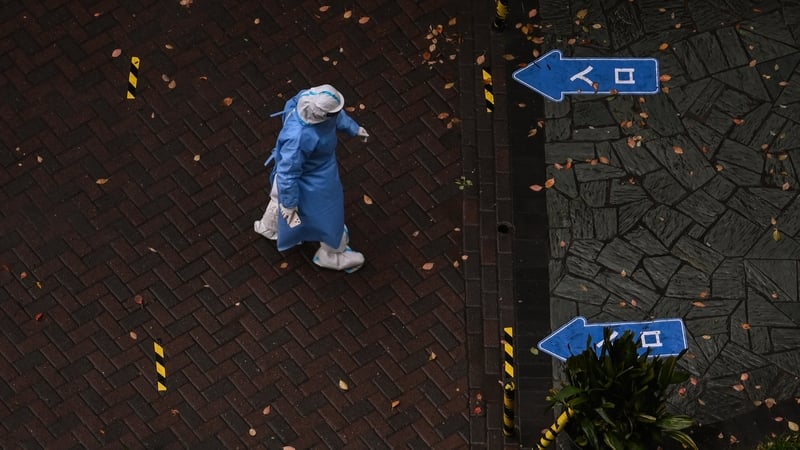 A health worker wearing PPE walks during a Covid-19 lockdown in Shanghai
