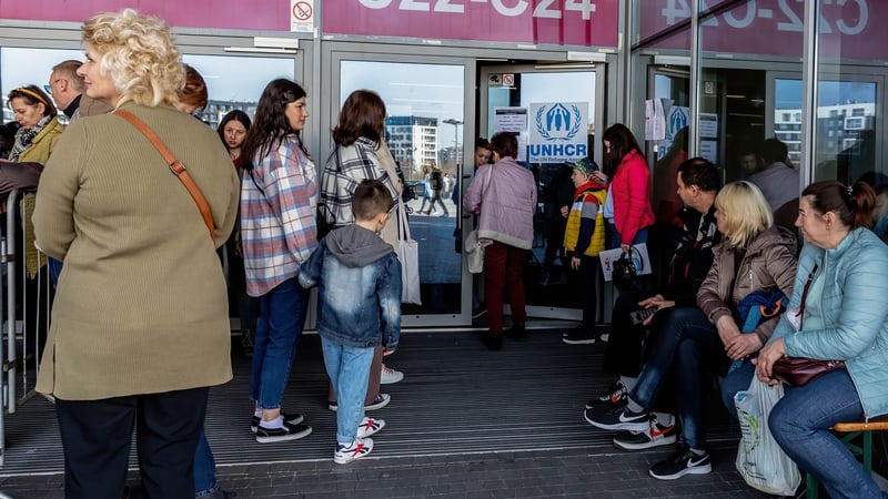 Ukrainian refugees queue to be registered by UNHCR after escaping the war in their country