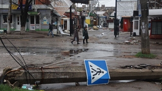 A view of damage in the street in the Ukrainian city of Mariupol