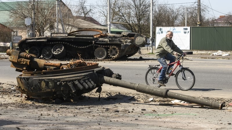 A man ride bike near Destroyed Russian military tank near Brovary