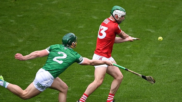 amien Cahalane of Cork scores his side's first goal despite the efforts of Sean Finn of Limerick