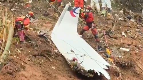 A screengrab from Chinese state TV shows rescuers searching the crash site
