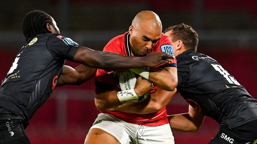 Munster's Simon Zebo is tackled by Yaw Penxe (L) and Curwin Bosch of Cell C Sharks