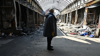 A woman at the remains of a local market in Kharkiv today after it was damaged by Russian shelling