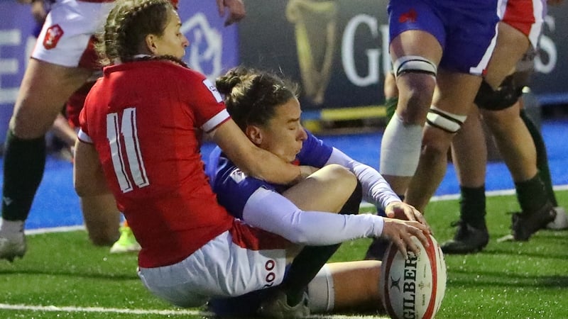 France's scrum-half Laure Sansus grounds the ball under pressure from Wales' wing Jasmine Joyce