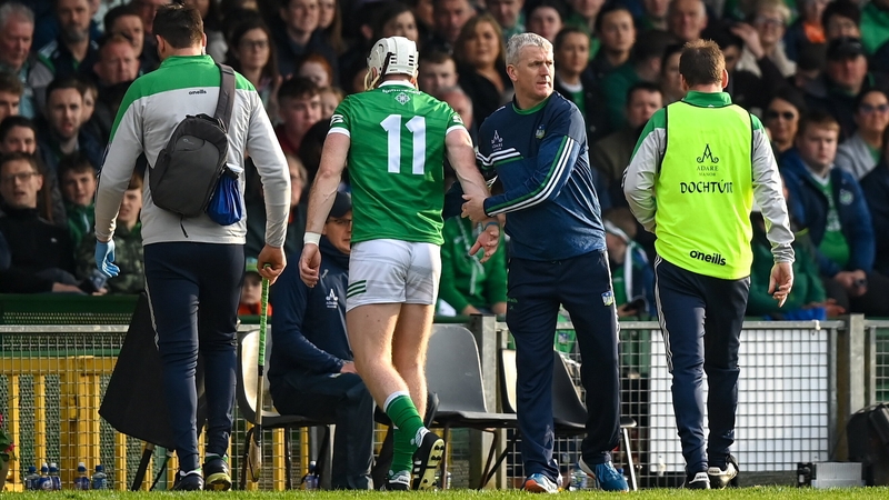 John Kiely (R) consoles Cian Lynch as he departs the field injured