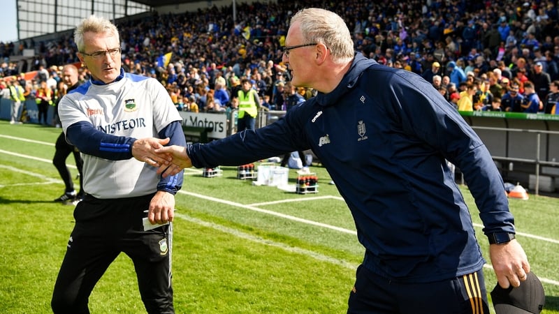 Tipperary manager Colm Bonnar (L) and Clare boss Brian Lohan shake hands after the game