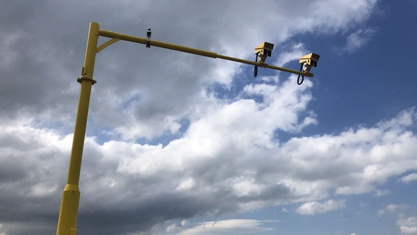 The cameras are giant in structure, built on large yellow poles erected high over the motorway