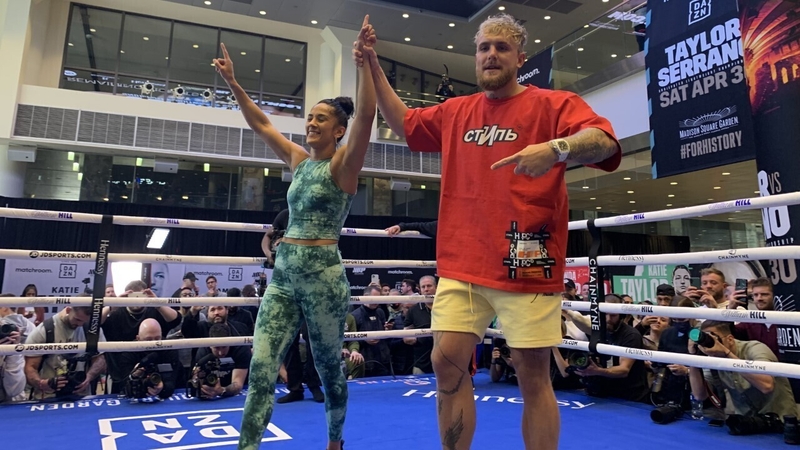 Jake Paul raises the hand of Amanda Serrano during the public workout at Madison Square Garden
