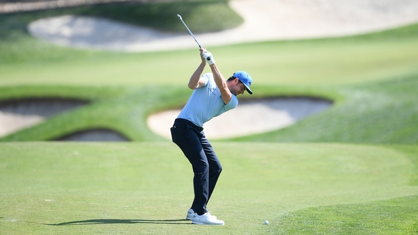 Laurie Canter plays his second shot on the ninth hole