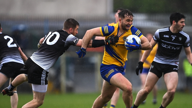 Roscommon's Eddie Nolan is tackled by Sligo's Keelan Cawley