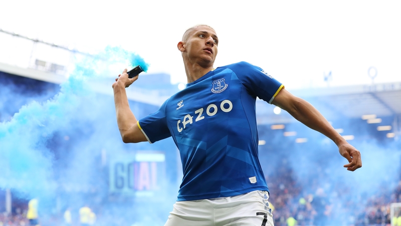 Richarlison celebrates after scoring against Chelsea after a flare was thrown onto the pitch