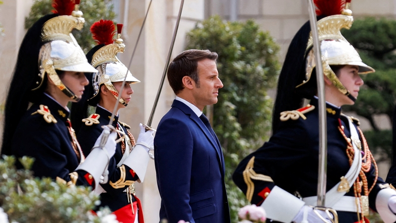 Emmanuel Macron reviews troops in the gardens of the Elysee presidential palace at his inauguration