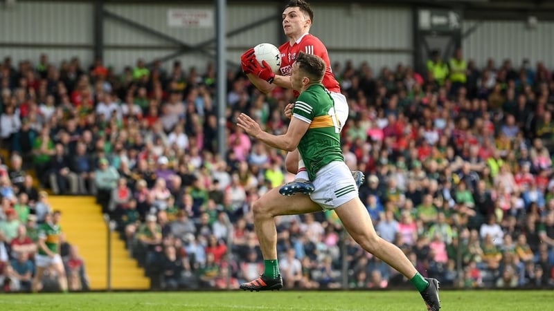 Cork's Sean Powter gathers possession ahead of David Clifford during last year's 12-point defeat to Kerry