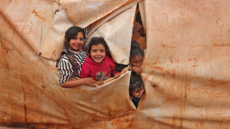 Children attend class in make-shift classrooms at a camp for the displaced in Syria's northwestern Idlib province