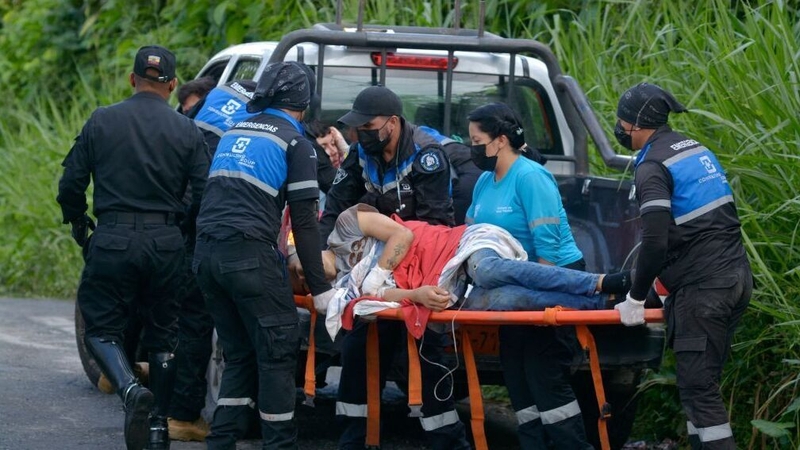 A wounded inmate is transported from a truck to an ambulance
