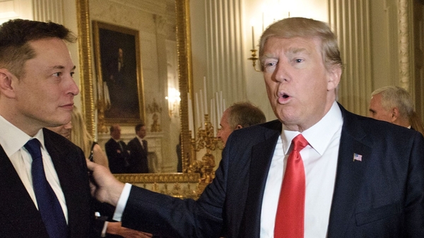 Donald Trump greets Elon Musk before a strategy forum with executives at the White House in 2017