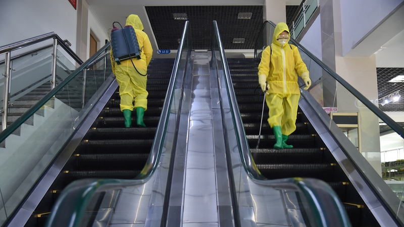 Employees spray disinfectant at the Pyongyang Children's Department Store in March