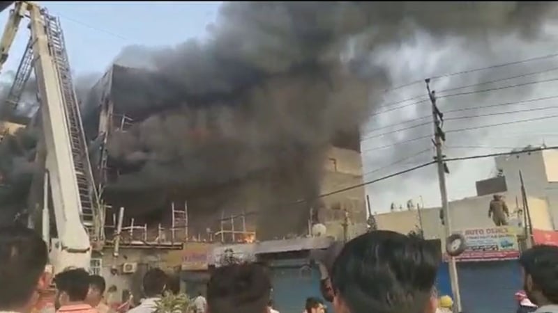 Smoke billowing from the building today in New Delhi, India