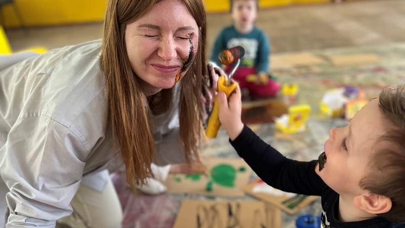 Lily Smirnova, who leads art classes at an orphanage set up to help young Ukrainian refugees, gets her face painted
