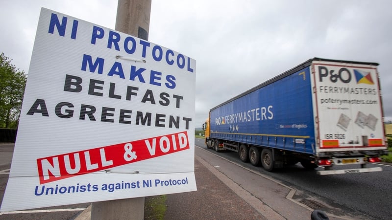 A lorry passes an anti Northern Ireland Protocol sign as it is driven away from Larne port (file pic)