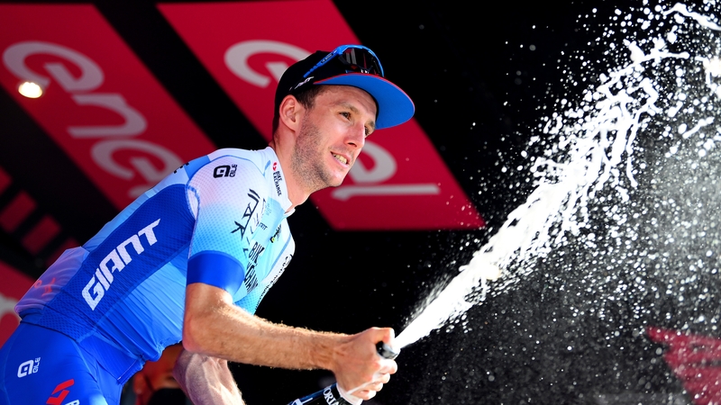 Simon Yates celebrates on the podium in Turin