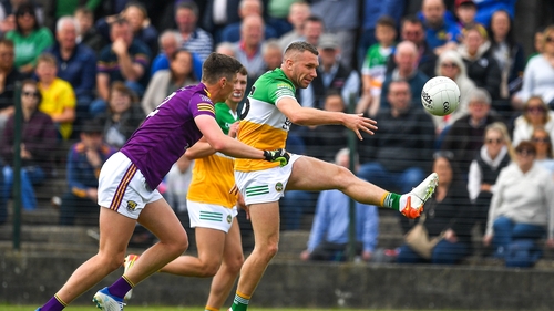 Anton Sullivan of Offaly in action against Gavin Sheehan of Wexford