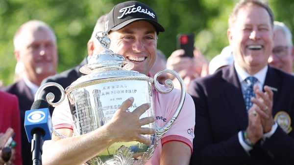 Justin Thomas hugs the hefty Wannamaker Trophy